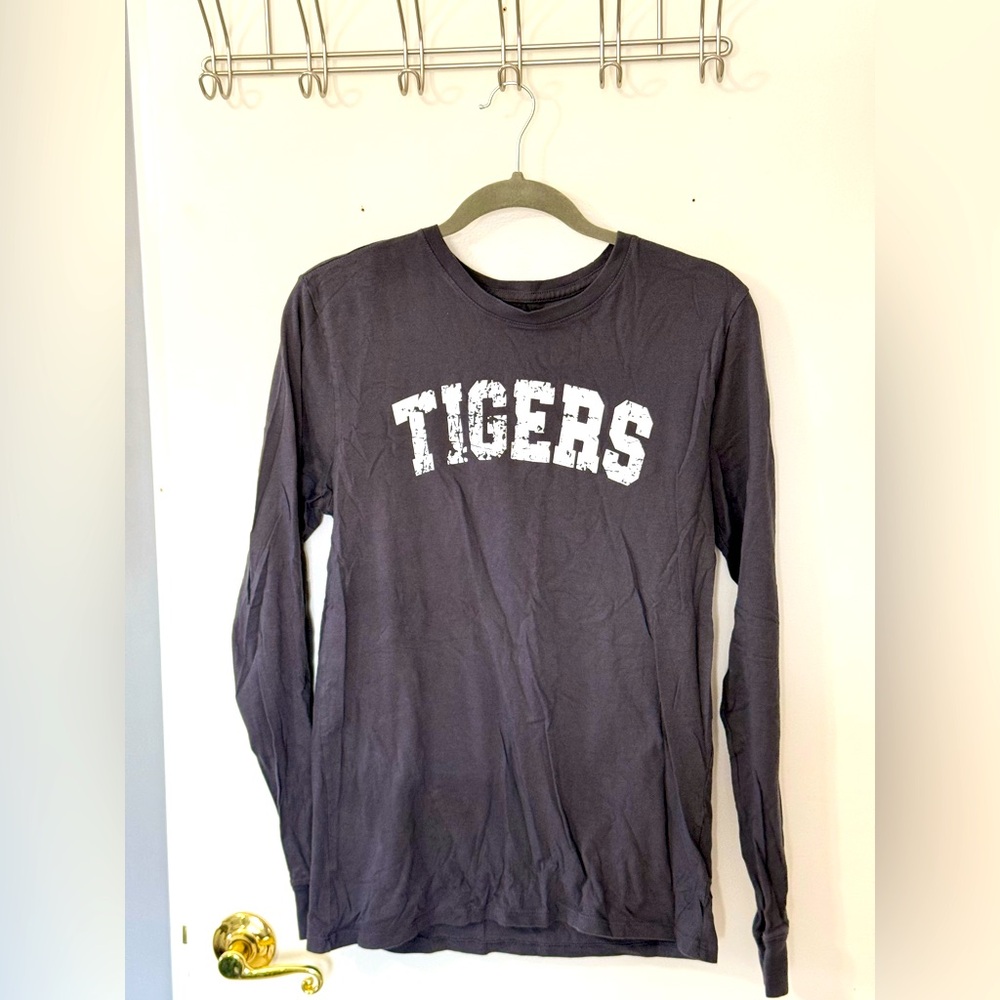 nike logo on the left arm of the shirt